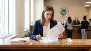 female attorney reviewing legal documents at Palm Beach County courthouse counter